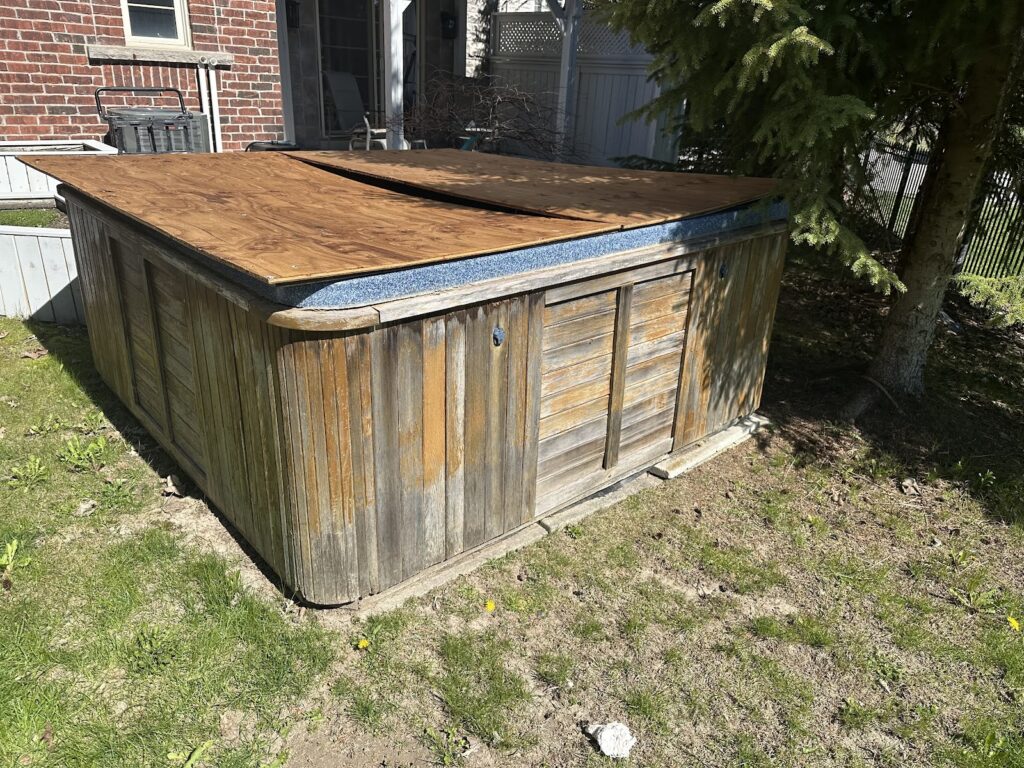 Old wooden hot tub in an Aurora backyard before removal by Don't Junk Yourself